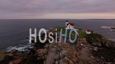 Flying Low Around Nubble Lighthouse Panning At Sunset. York Maine - Video Drone Footage