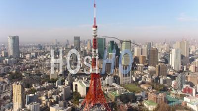 Japan Tokyo Aerial Flying Low Backwards Away From Tokyo Tower With Cityscape Views - Video Drone Footage