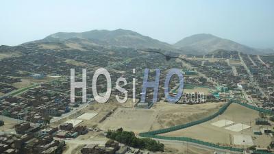 Ventanilla Peru Flying Low Over Urban Poverty Hillside Housing Area. - Video Drone Footage