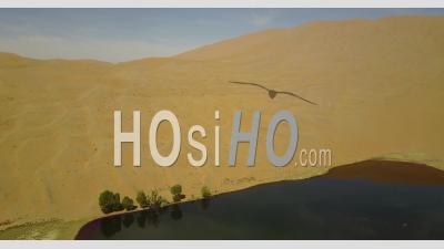 Lake In The Middle Of Sand Dunes In The Gobi Desert In China