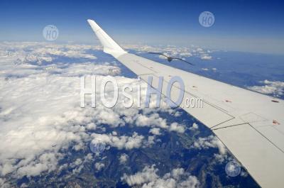 Wing Of Flying Airplane Over French Alps, France, (aerial View) - Aerial Photography