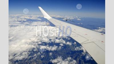 Wing Of Flying Airplane Over French Alps, France, (aerial View) - Aerial Photography