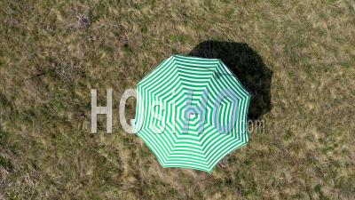 Video Drone Footage Of A Stripped Green Sun Umbrella