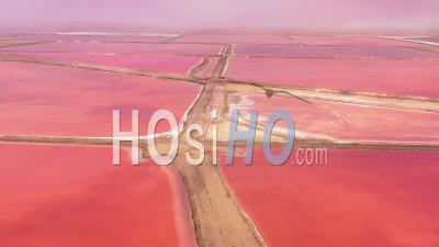 Aerial View Over Bright Red And Pink Salt Pan Farms Near Walvis Bay, Namibia - Video Drone Footage