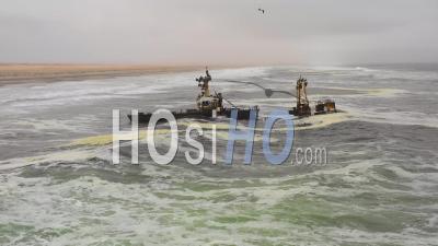 Dramatic Aerial View Over A Spooky Shipwreck Grounded Fishing Trawler Along The Skeleton Coast Of Namibia - Video Drone Footage