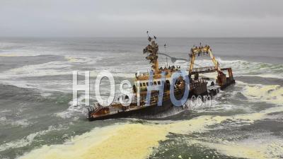 Dramatic Aerial View Over A Spooky Shipwreck Grounded Fishing Trawler Along The Skeleton Coast Of Namibia - Video Drone Footage