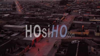 Aerial View Over Township In South Africa, Vast Poverty And Ramshackle Huts, At Night Or Dusk - Video Drone Footage