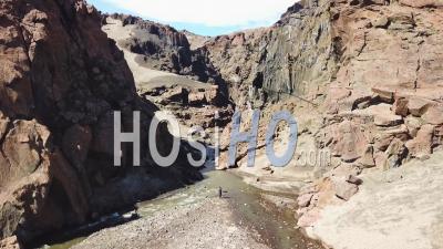 Aerial View Over A Woman Walking Into A Deep And Mysterious Canyon In Askja, Central Highlands Of Iceland - Video Drone Footage