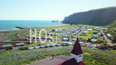 Aerial View Of The Town Of Vik In Southern Iceland Its Iconic Church - Video Drone Footage