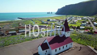 Vue Aérienne De La Ville De Vik Dans Le Sud De L'islande, Son église Emblématique - Vidéo Drone