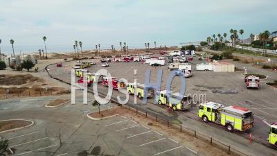 Aerial View Of Firefighters In Fire Trucks Lining Up For Duty At A Staging Area During The Thomas Fire In Ventura, California In 2017 - Video Drone Footage