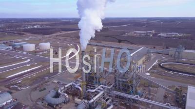 Aerial View Over An Oil Refinery Spewing Pollution Into The Air - Video Drone Footage