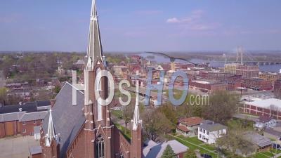 Aerial Shot Over Small Town America Church Reveals Burlington Iowa With Mississippi River Background - Video Drone Footage