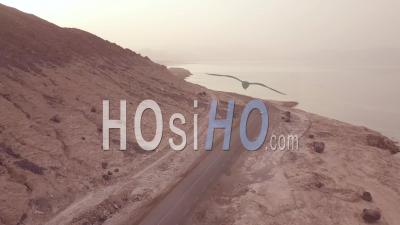 Aerial View Above A Pickup Truck Driving On A Coastal Road In Somalia Or Djibouti - Video Drone Footage