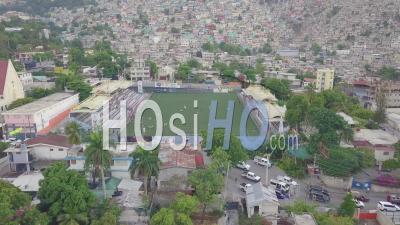 Aerial View Over The Slums, Favela And Shanty Towns In The Cite Soleil District Of Port Au Prince, Haiti With Soccer Stadium Foreground - Video Drone Footage