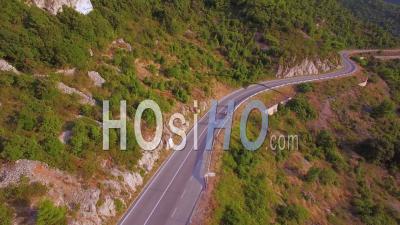 Aerial View Over Three People Riding Mopeds Or Vespa Scooters Along A Two Land Mountain Road In Croatia - Video Drone Footage