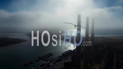 Aerial View Over Large Power Plant Smokestacks In The Fog Near Morro Bay, California - Video Drone Footage