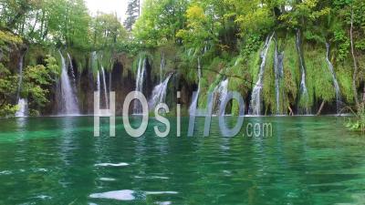 Beautiful Waterfalls Flow Through Lush Green Jungle At Plitvice National Park In Croatia - Video Drone Footage