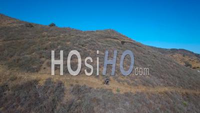 Aerial View Of A Mountain Biker Ascending A California Mountain - Video Drone Footage