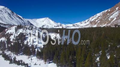 Aerial View Over Very Remote Snow Covered Mountains In The Sierra Nevadas - Video Drone Footage