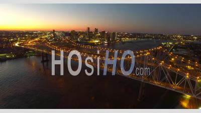 Night Aerial View Of The Crescent City Bridge Over The Mississippi River Revealing The New Orleans Louisiana Skyline - Video Drone Footage