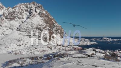 Snowy Landscape With Mountains And Ocean In The Lofoten Islands - Norway - Video Drone Footage