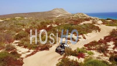 Aerial View Over An Atv Speeding Across The Sand In Cabo San Lucas, Baja, Mexico - Video Drone Footage