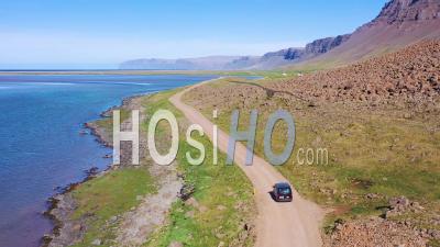Aerial View Over A Black Van Traveling On A Dirt Road In Iceland, Near Raudisandur Beach In The Northwest Fjords - Video Drone Footage