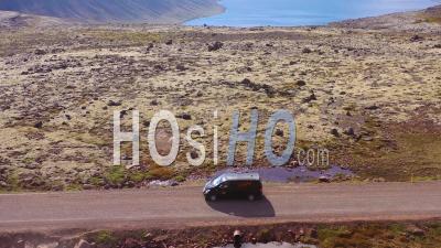 Aerial View Over A Black Camper Van Traveling On A Dirt Road In Iceland In The Northwest Fjords - Video Drone Footage