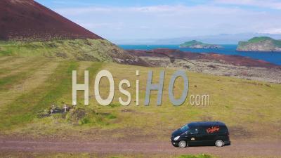 Aerial View Over A Black Camper Van Traveling On A Dirt Road In Iceland In The Westmann Islands - Video Drone Footage