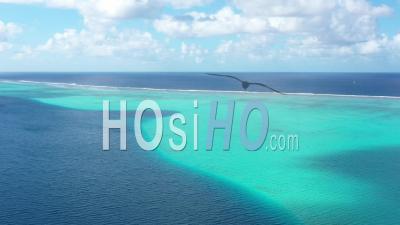 Aerial View Of A Coral Barrier In French Polynesia - Video Drone Footage