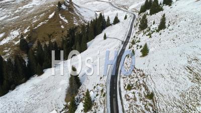 Car Driving On A Mountain Road During Winter - Video Drone Footage