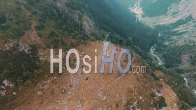 Aerial Tracking Shot Of A Cable Car Climbing Down - Video Drone Footage