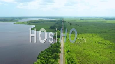 Aerial View Of An Open Area Landscape,Long Open Road, Lake And Lots Of Green