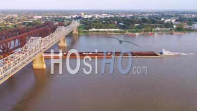 River Barge Under Three Steel Bridges Over The Mississippi River With Memphis, Tennessee Background - Aerial Video By Drone