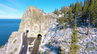 2020- Winter Snow Aerial Cave Rock Tunnel Along The Eastern Shore Of Lake Tahoe, Nevada, With Road And Traffic Below - Video Drone Footage