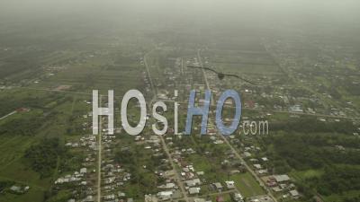 Remote Suburban Town On Edge Of Suriname Rainforest On Overcast Day, Aerial - Video Drone Footage