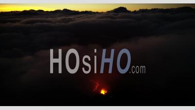 Over The Clouds With Volcano Eruption - Video Drone Footage