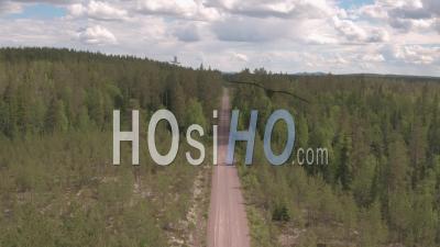 Aerial View Along A Track In The Middle Of A Fir Trees Forest, Tackasen, Sweden - Video Drone Footage