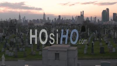 Rising Aerial Of Vast Cemetery In New York City Suggests Victims From Coronavirus Covid-19 Pandemic Epidemic Outbreak Deaths. - Video Drone Footage