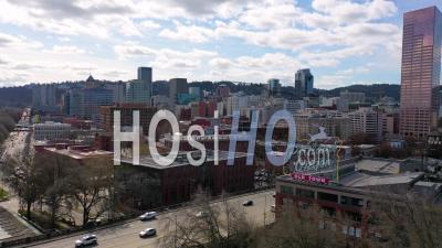 Aerial Past Portland Oregon Stag Deer Sign And Downtown Old Town Cityscape And Business District. - Video Drone Footage