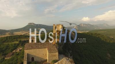 Church And A Ruined Castle On The Top Of A Cliff Over A Small Village, France - Video Drone Footage