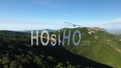Green Mountains And Cliffs Under A Blue Sky In South Of France - Video Drone Footage