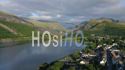 Idyllic, Picturesque Llanberis Town In Wales, With Mountains Landscape And Forest Scenery Beside Padarn Lake, Aerial Drone View