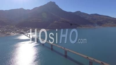 Pont De Savines Road Bridge And The Lac De Serre-Poncon Lake, Savines Le Lac, French Alps, France – Aerial Video Drone Footage 