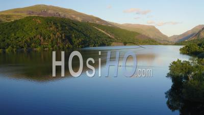 Tranquil Scene Of One Boat On Lake At Snowdonia National Park In Wales - Aerial Drone