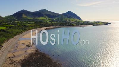 Stunning Lush Coast Landscape Of Wales With Famous Impressive Yr Eifl Mountains Scenery In Background Of Beach, Aerial Drone View