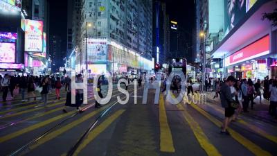 People Crossing At The Pedestrian Lane In Hong Kong Before The Buses Go At Night - Timelapse