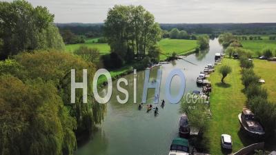 People Paddling Kayak On River Thames In Abingdon Town, Oxford City, Uk During Summertime. - Aerial Drone Shot