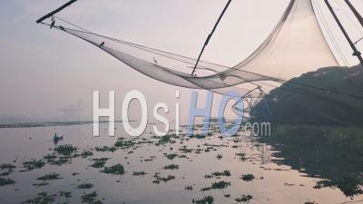 Traditional Chinese Fishing Nets At Sunrise, Fort Kochi, India. Low Aerial Drone